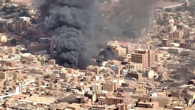 An aerial view of the black smoke and flames at a market in Omdurman