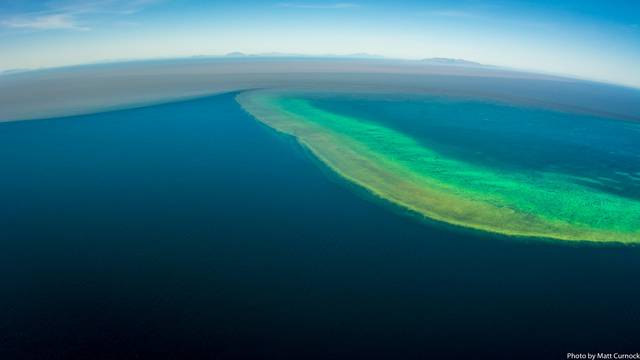 Sediment-filled water is seen in the Great Barrier Reef