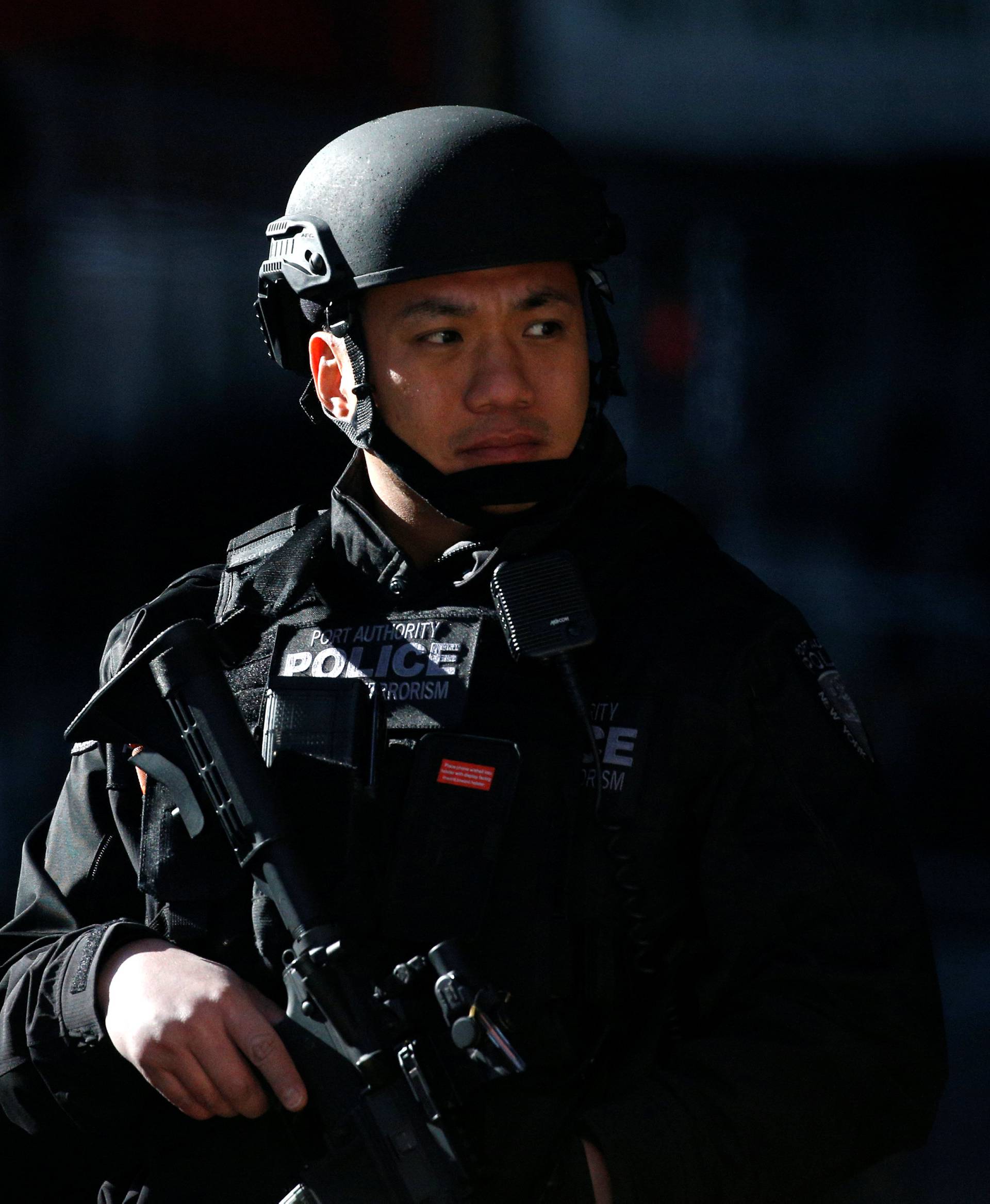A police officer stands guard outside the New York Port Authority Bus Terminal after reports of an explosion in New York City