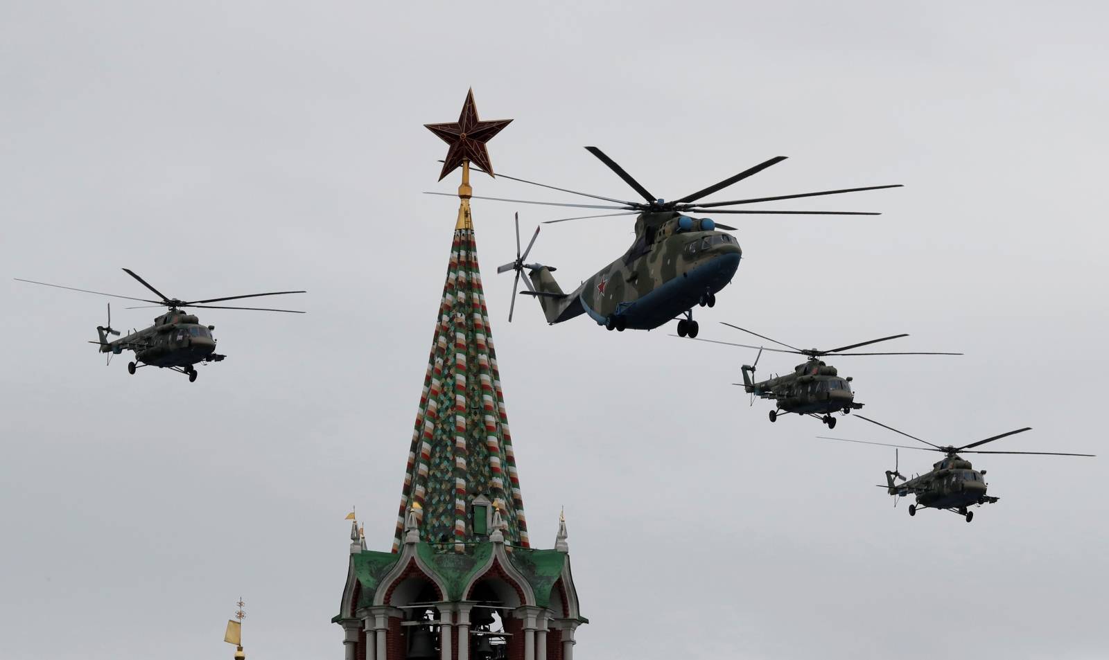 Helicopters fly in formation during an air parade on Victory Day in central Moscow