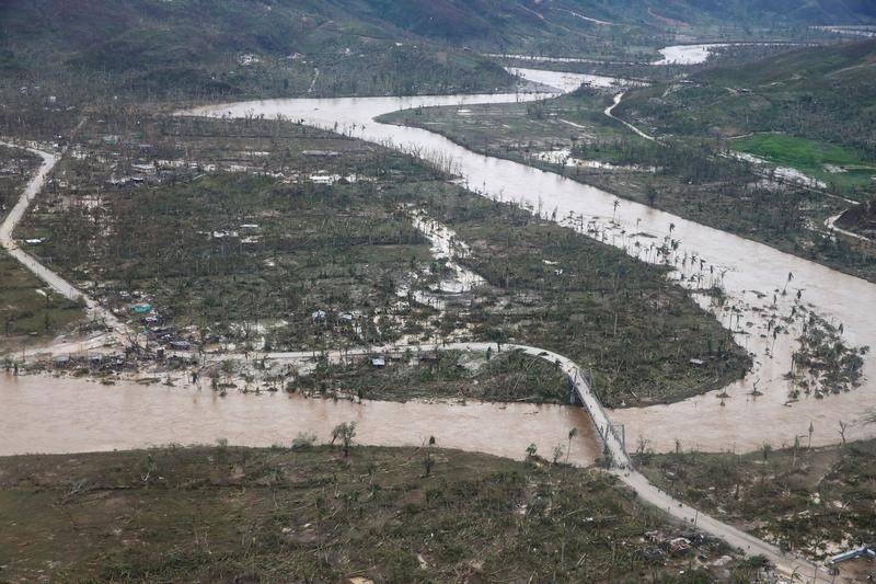A flooded river and destroyed houses are seen after Hurricane Matthew passes Jeremie, Haiti