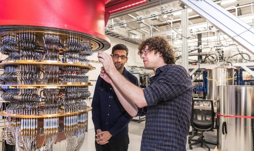 A handout picture shows Pichai and Sank with one of Google's Quantum Computers in the Santa Barbara lab