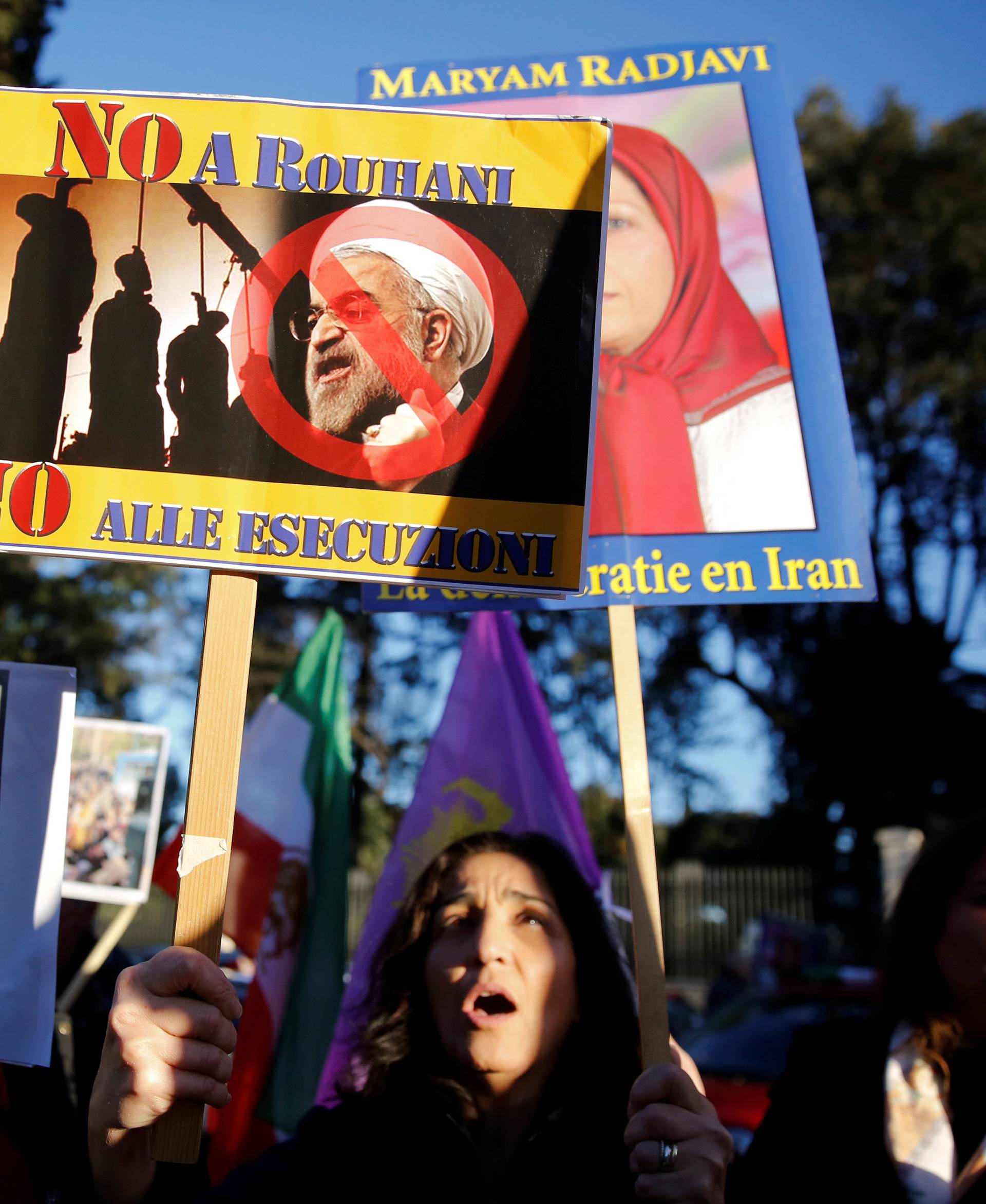 Opponents of Iranian President Hassan Rouhani hold a protest outside the Iranian embassy in Rome