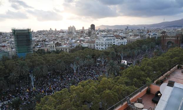 People attend a pro-indpendence rally near the Catalan regional parliament in Barcelona