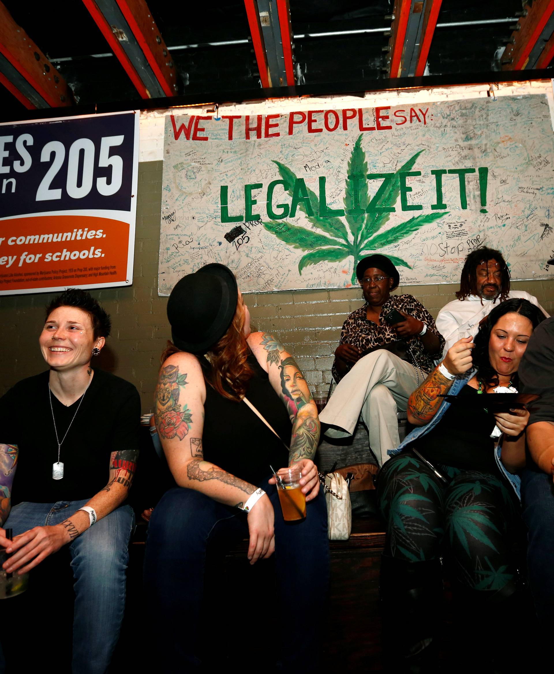 People gather for an election watch party put on by supporters of a legal marijuana initiative in Phoenix, Arizona