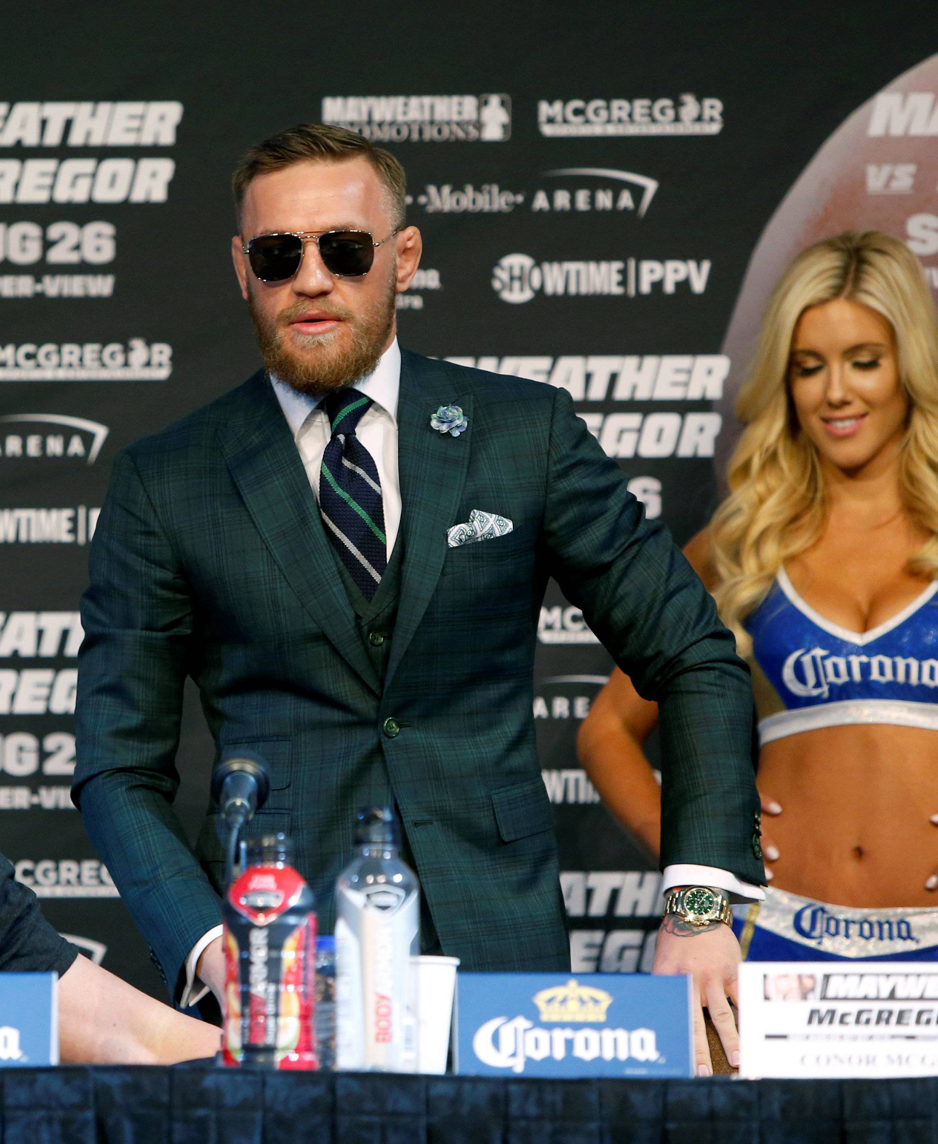 UFC lightweight champion Conor McGregor (C) of Ireland arrives for a news conference in Las Vegas