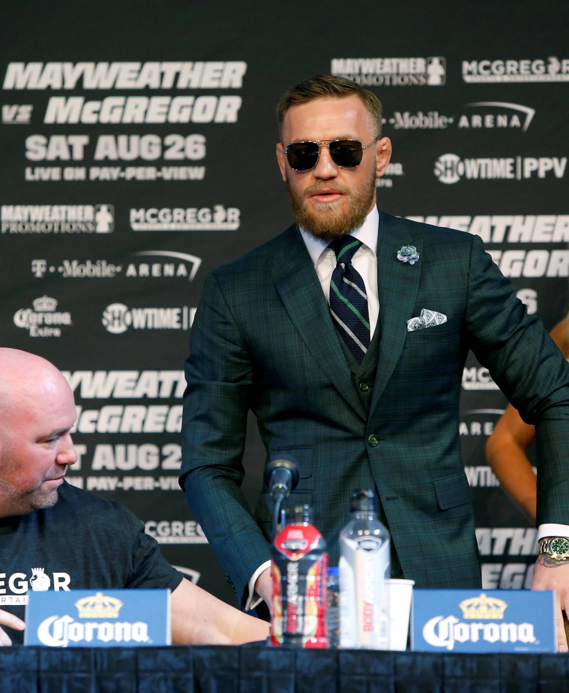 UFC lightweight champion Conor McGregor (C) of Ireland arrives for a news conference in Las Vegas