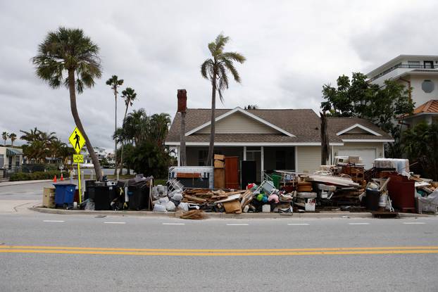 Debris from Hurricane Helene is seen on the roadside as residents evacuate before the arrival of Hurricane Milton, in St. Pete Beach, Florida