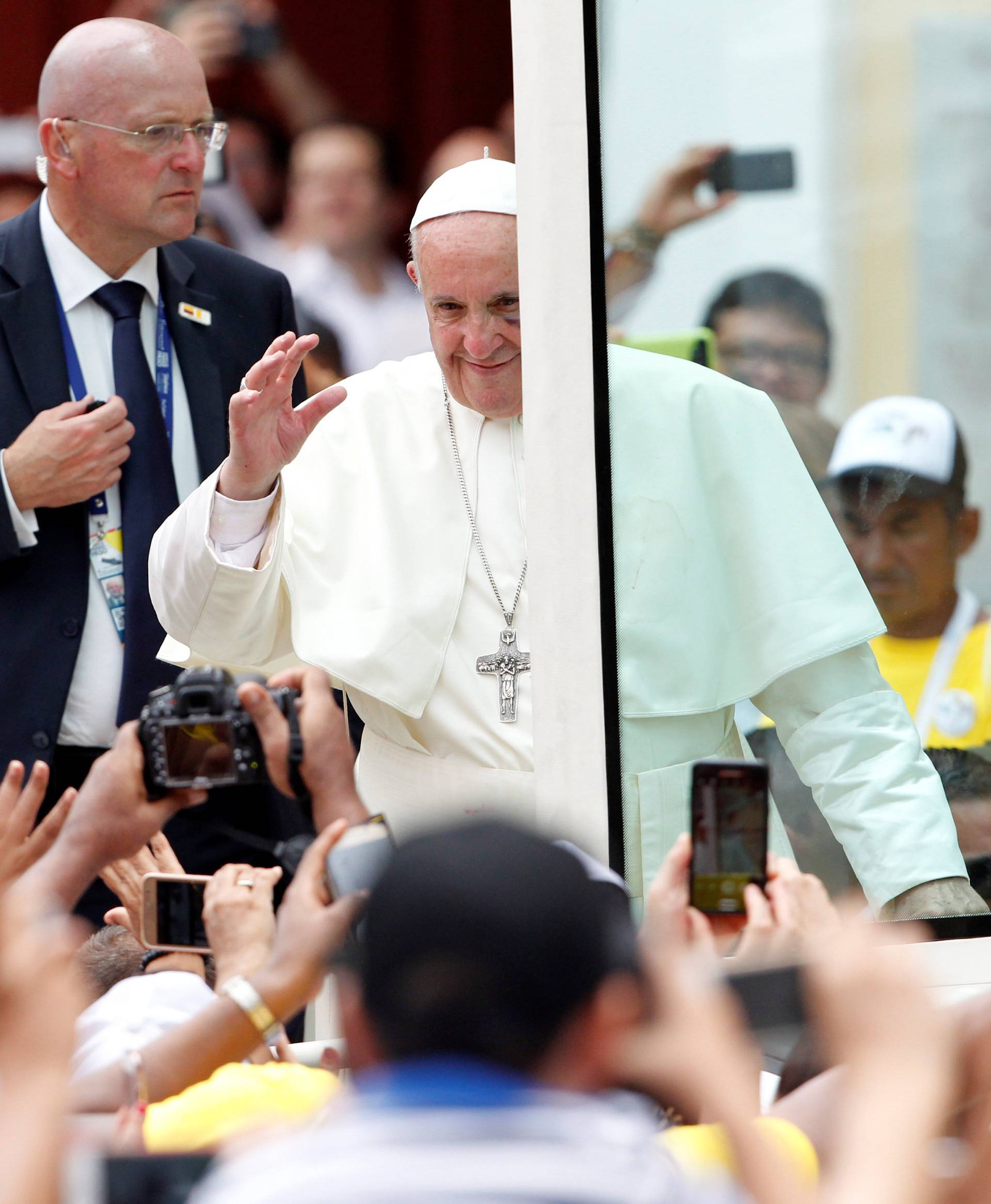 Pope Francis greets faithfuls as he travels in the popemobile through Cartagena, Colombia