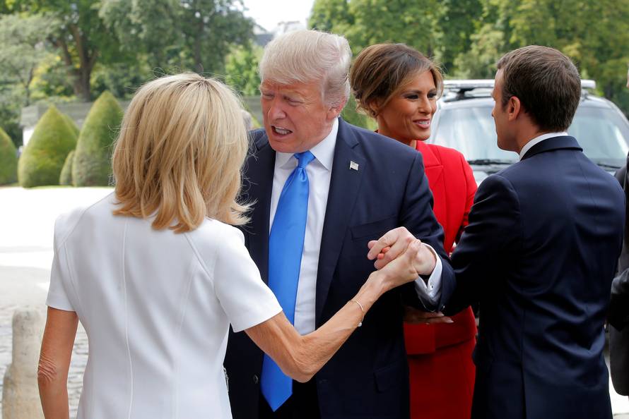 French President Emmanuel Macron greets US First Lady Melania Trump while his wife Brigitte Macron welcomes US President Donald Trump at Les Invalides museum in Paris