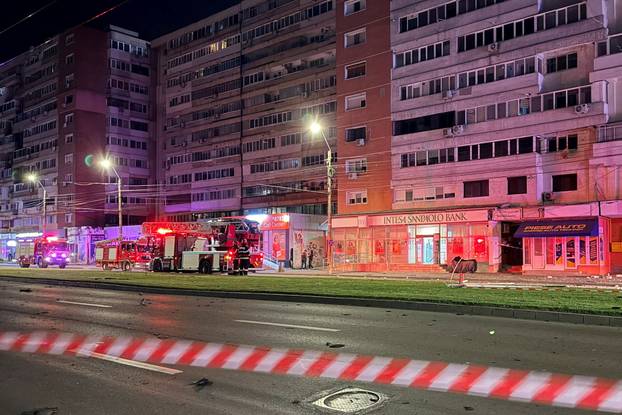 Firefighters and law enforcement work on the site of a explosion at a residential block of flats following a drone hit close to the border with Ukraine