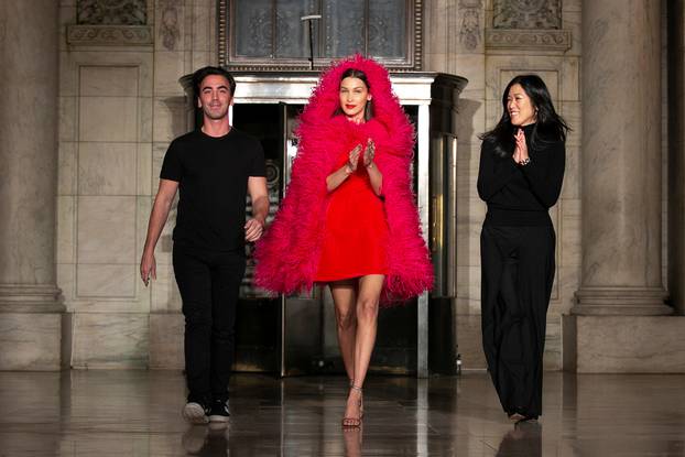 Designers Laura Kim and Fernando Garcia walk with model Bella Hadid after presenting the Oscar de la Renta Fall 2020 collection during New York Fashion Week
