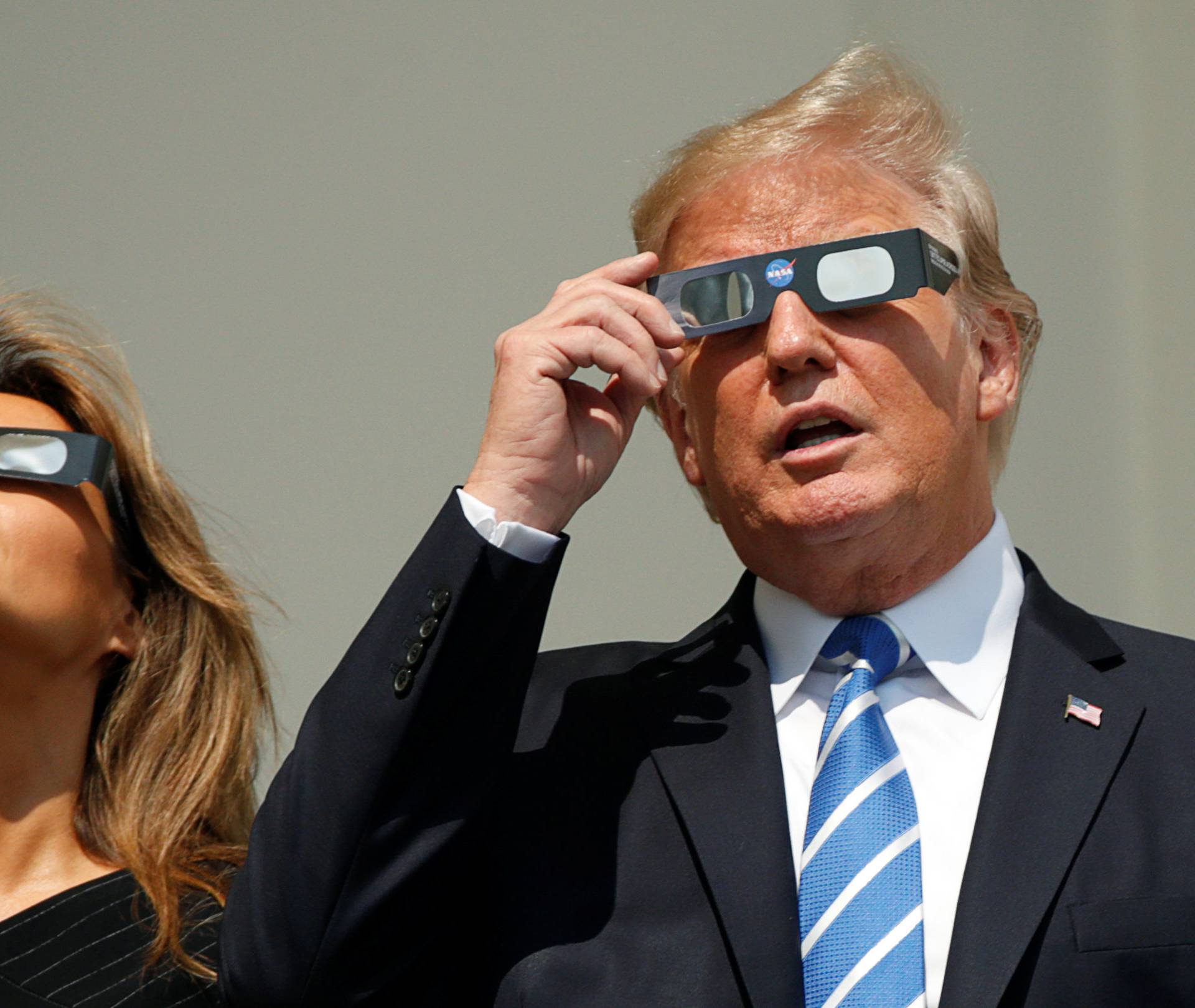 U.S. President Donald Trump and Melania Trump watch the solar eclipse from the White House in Washington