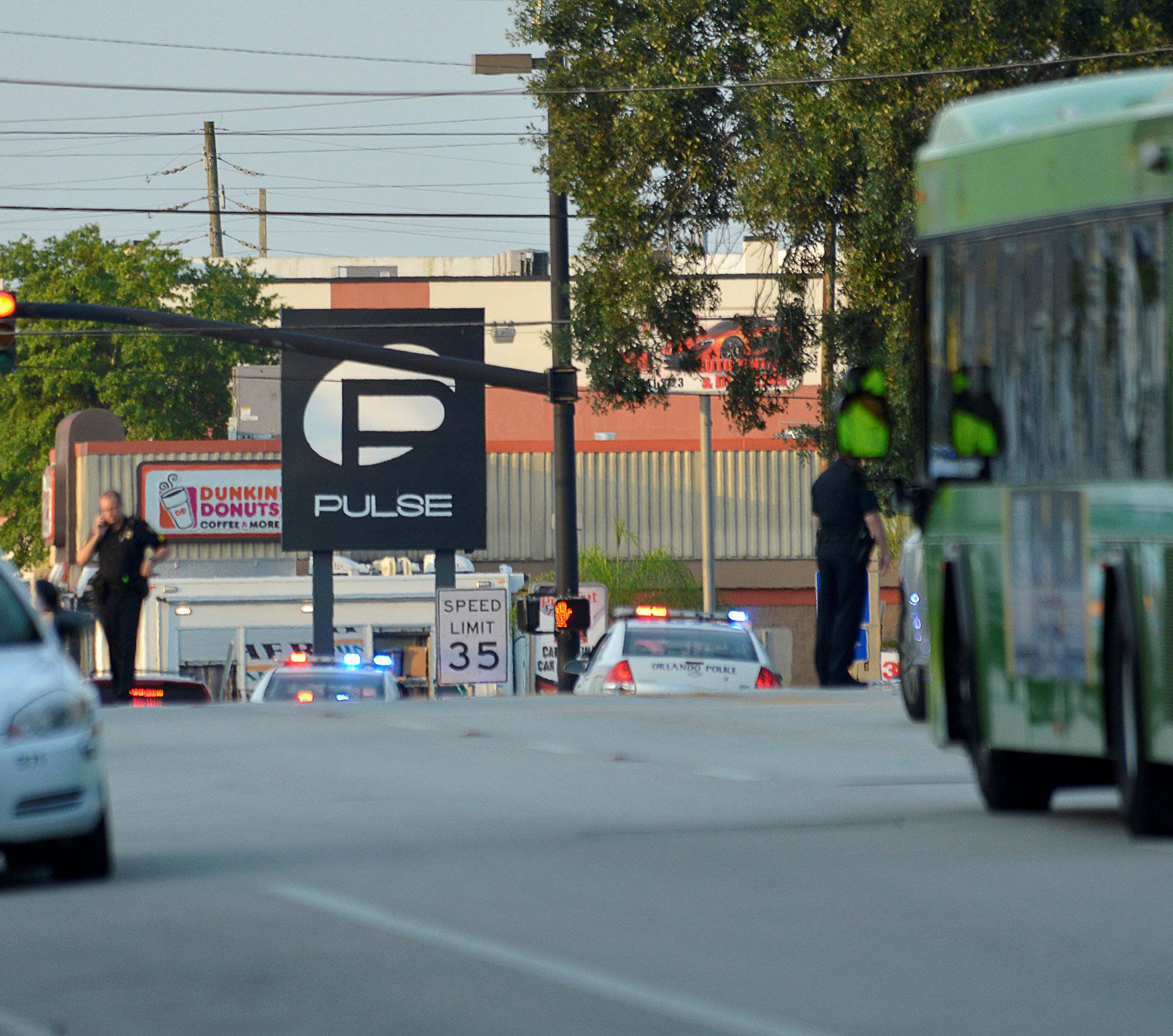 Police lock down Orange Avenue around Pulse nightclub, where people were killed by a gunman in a shooting rampage in Orlando