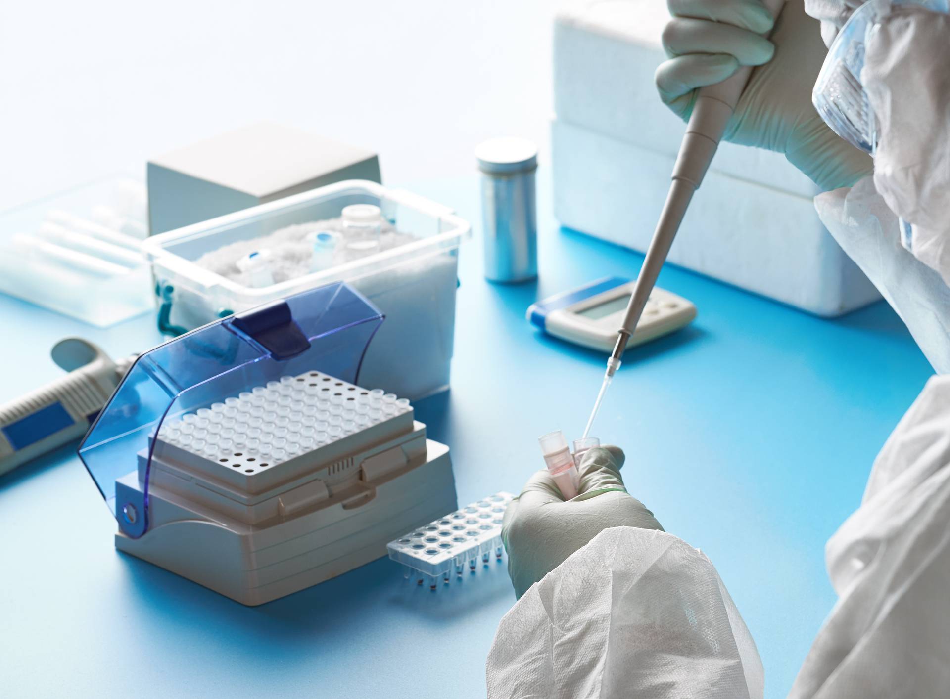 SARS-COV-2 pcr diagnostics kit. Epidemiologist in protective suit, mask and glasses works with patient swabs to detect specific region of 2019-nCoV virus causing Covid-19 viral pneumonia.