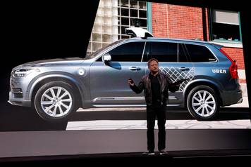 Jensen Huang, CEO of Nvidia, announces that Nvidia and Uber will partner to build self-driving cars during his keynote address at CES in Las Vegas
