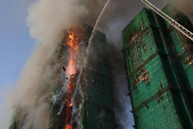 Flames engulf bamboo scaffolding across multiple buildings at Wang Fuk Court housing estate, in Tai Po
