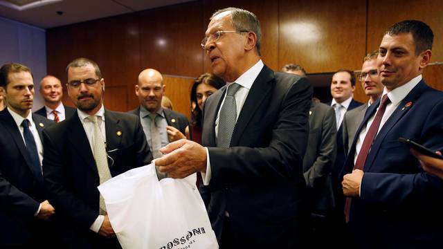 Vodka is delivered to reporters awaiting John Kerry and Russian Foreign Minister Sergei Lavrov to hold a press conference in Geneva