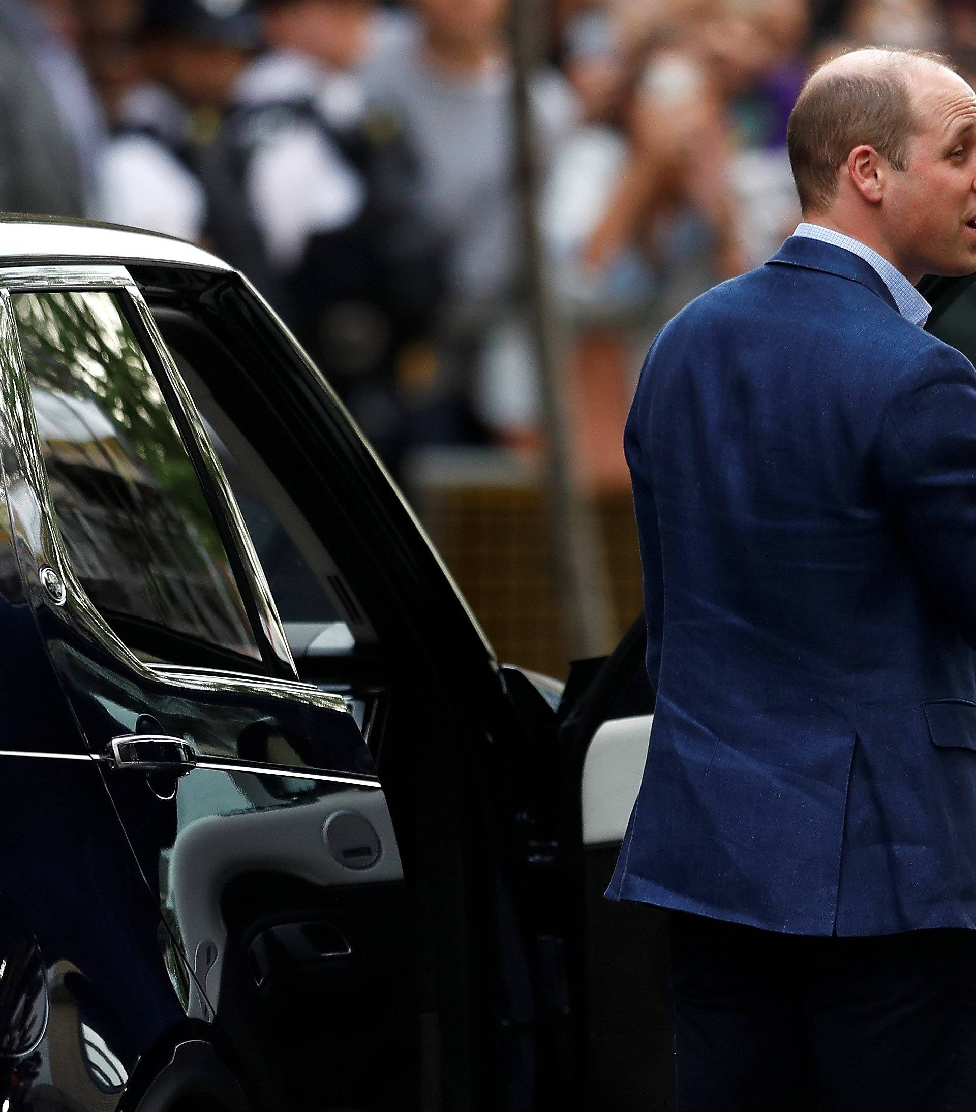 Britain's Prince William gestures as he prepares to leave Lindo Wing of St Mary's Hospital with Catherine, the Duchess of Cambridge and their new baby boy in London