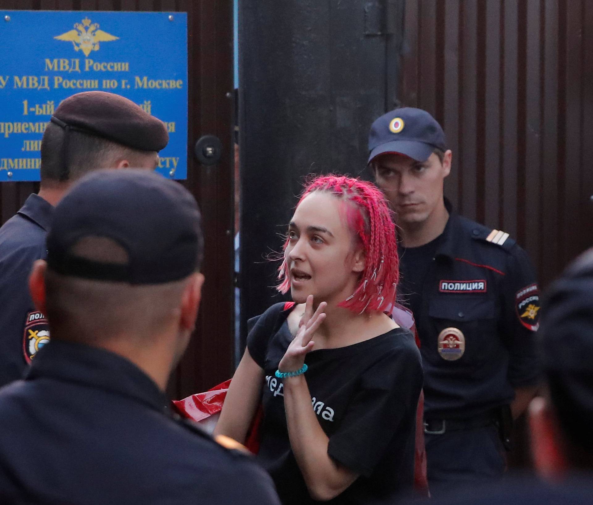 One of four intruders affiliated to anti-Kremlin punk band Pussy Riot, Kurachyova, who ran onto the pitch during the World Cup final between France and Croatia, talks to police officers after leaving 15-day jail outside a detention center in Moscow