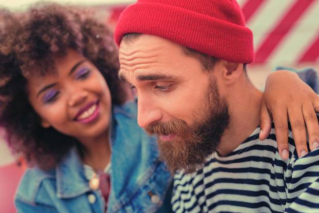 Young girl smiling to her boyfriend and encouraging him after party