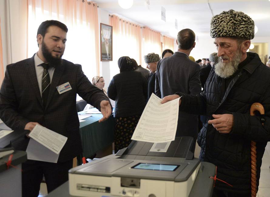 A man casts his vote at a polling station during the presidential election in Tsentoroy