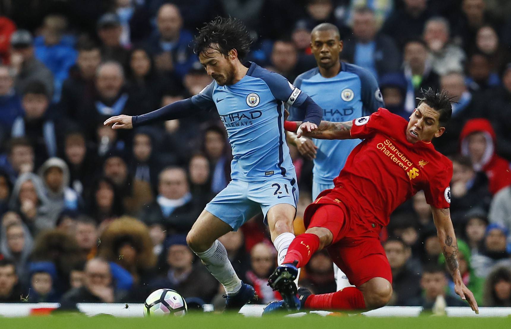 Liverpool's Roberto Firmino fouls Manchester City's David Silva