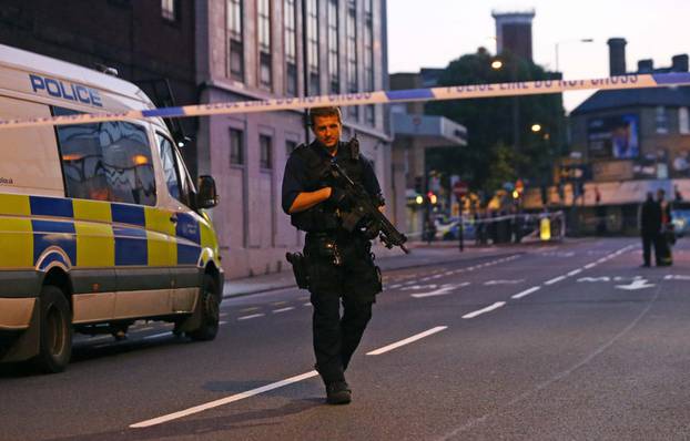 Police officers attend to the scene after a vehicle collided with pedestrians in the Finsbury Park neighborhood of North London