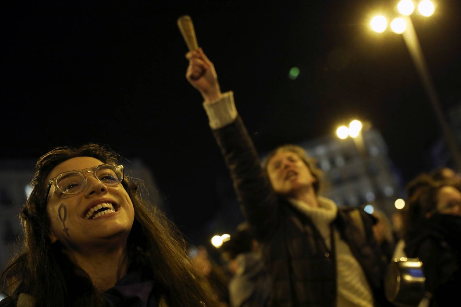 Women bang pots and pans during a protest at the start of a nationwide feminist strike on International Women's Day at Puerta del Sol Square in Madrid