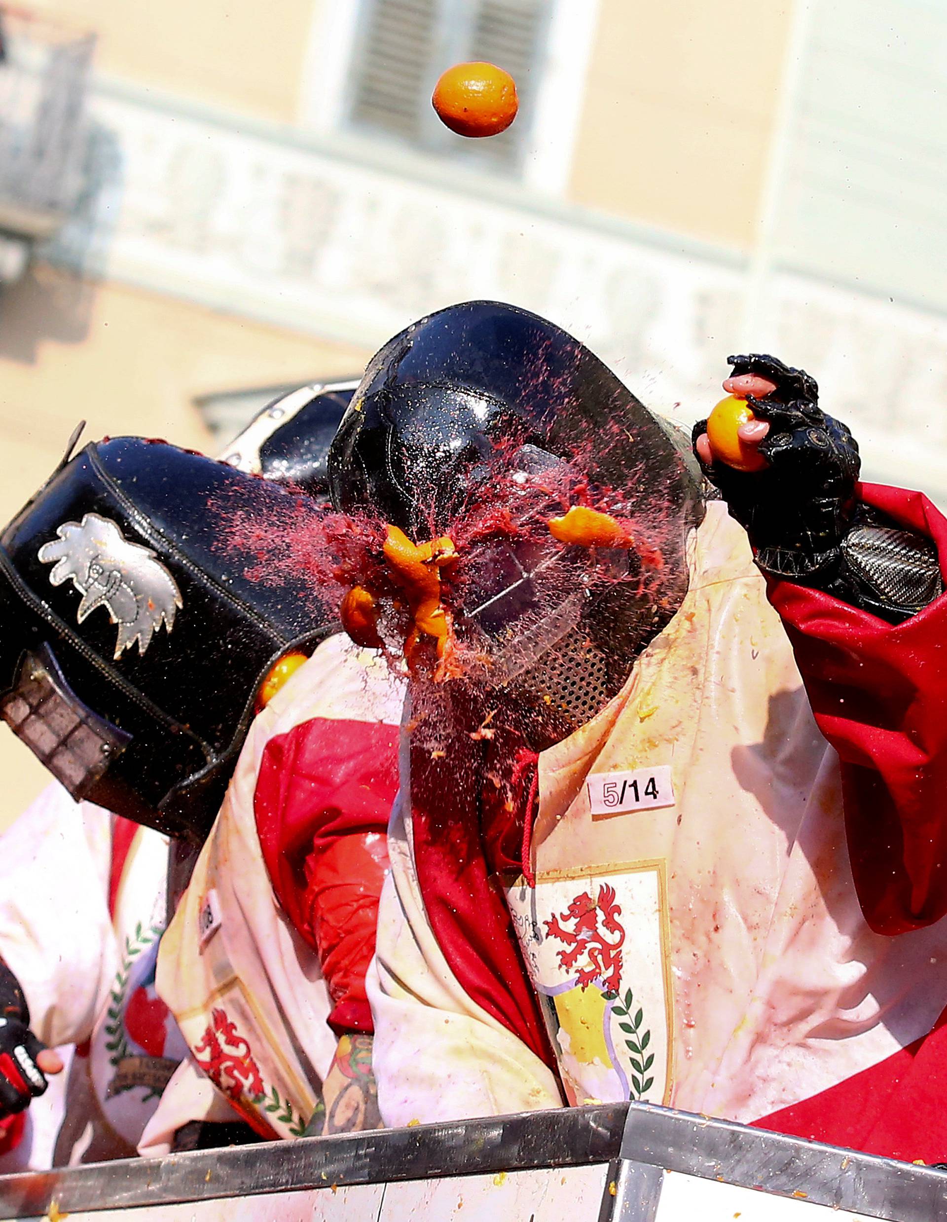 Members of rival teams fight with oranges during an annual carnival battle in the northern Italian town of Ivrea