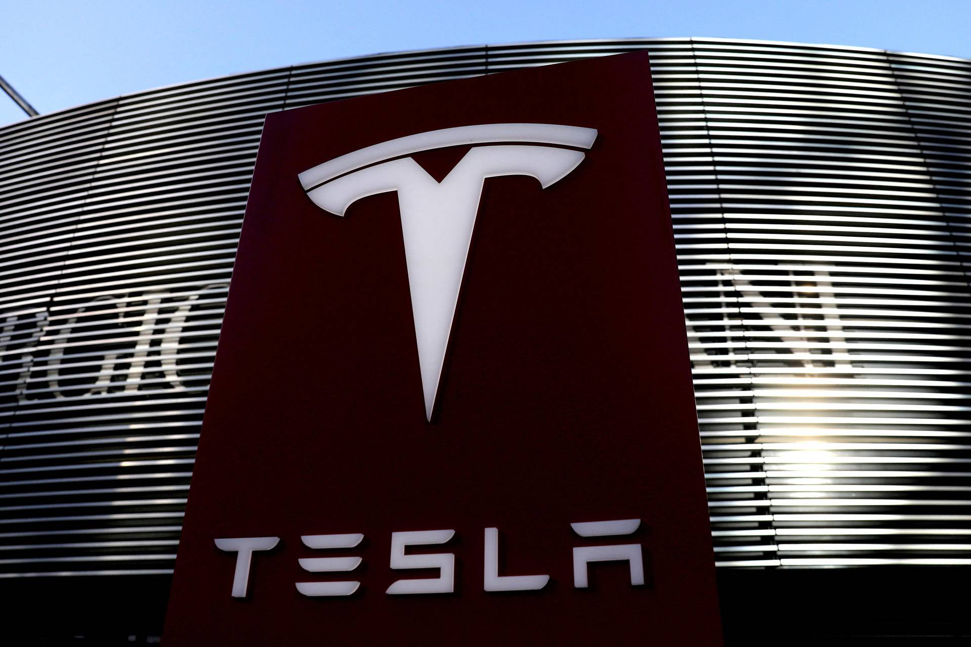 FILE PHOTO: Logo of the electric-vehicle maker Tesla is seen near a shopping complex in Beijing