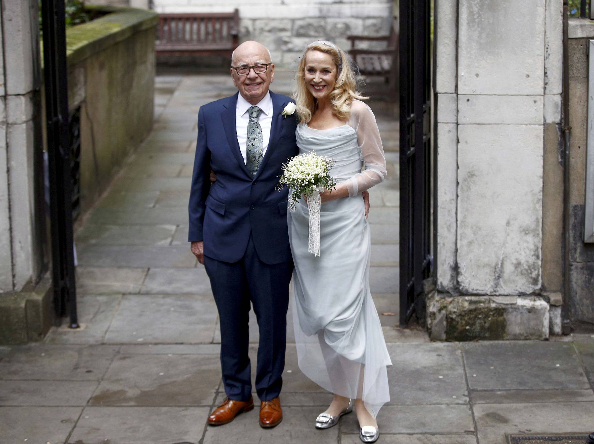 FILE PHOTO: Media Mogul Rupert Murdoch and former supermodel Jerry Hall pose for a photograph outside St Bride's church following a service to celebrate their wedding which took place on Friday, in London