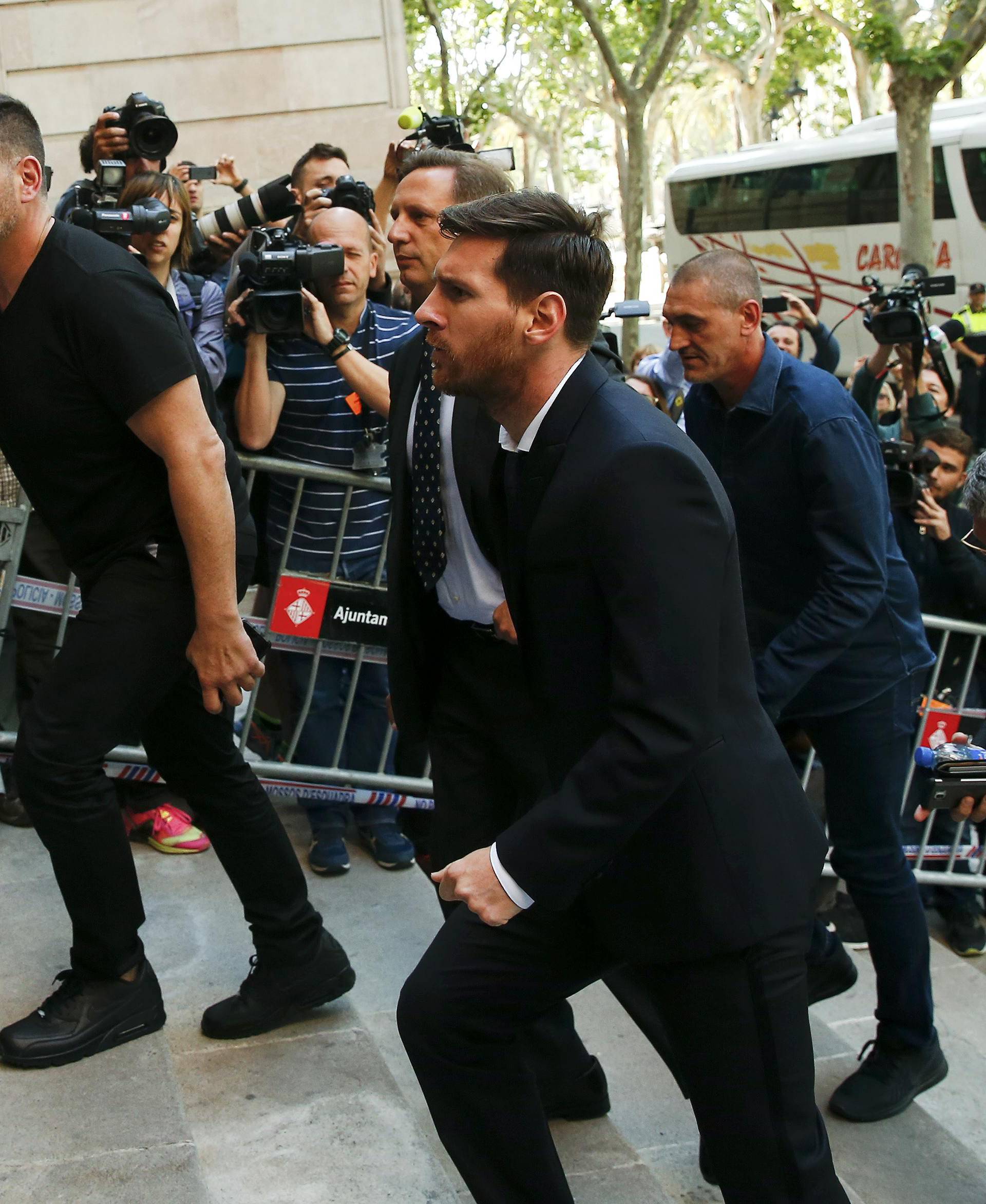Barcelona's Argentine soccer player Lionel Messi arrives to court with his father Jorge Horacio Messi to stand trial for tax fraud in Barcelona