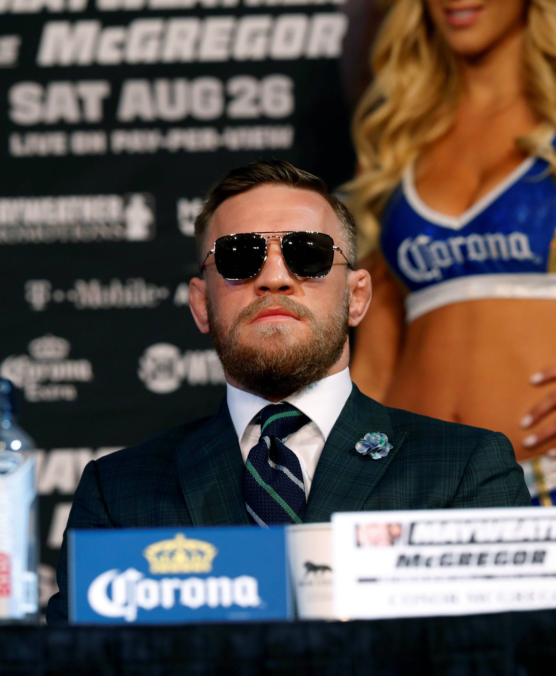 Conor McGregor of Ireland listens to Floyd Mayweather Jr. of the U.S. during a news conference in Las Vegas