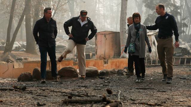 President Donald Trump visits the charred wreckage of Skyway Villa Mobile Home and RV Park with Governor-elect Gavin Newsom Brock Long Paradise Mayor Jody Jones and Governor Jerry Brown in Paradise California