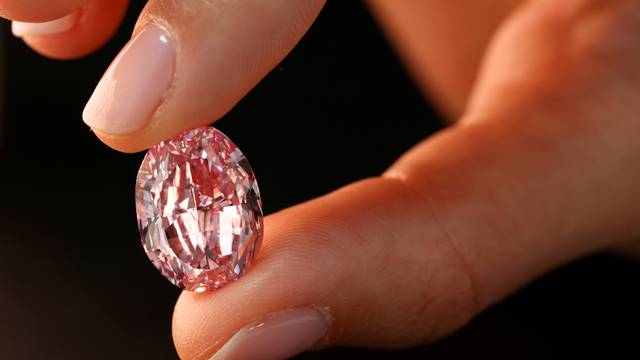 FILE PHOTO: A model poses with "The Spirit of the Rose" purple-pink diamond in Geneva