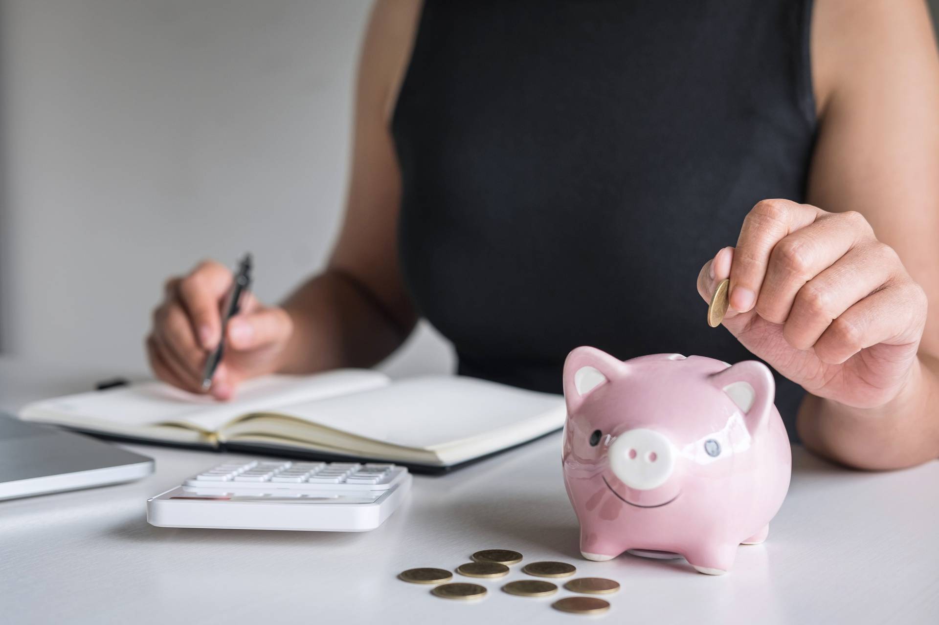 Woman,Putting,Golden,Coin,In,Pink,Piggy,Bank,For,Step