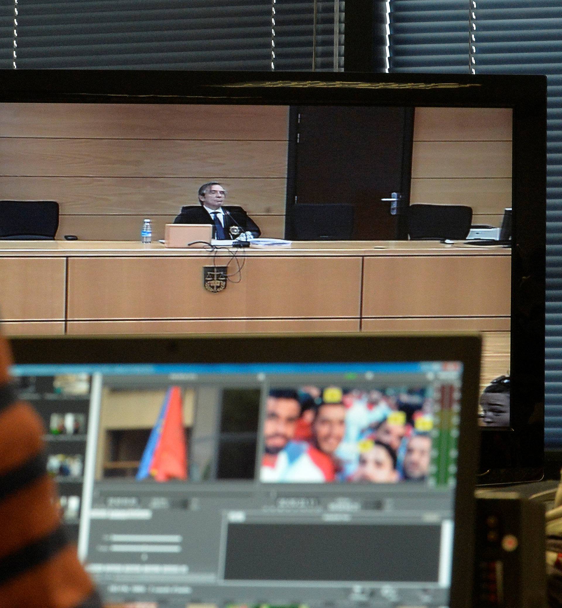 Jose Francisco Cobo, magistrate from the High Court of Navarra, is seen on screen as he delivers a nine-year prison sentence on five men accused of the multiple rape of a woman during Pamplona's San Fermin festival in 2016, in Pamplona
