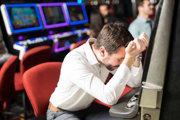 Stressed man losing money in a casino