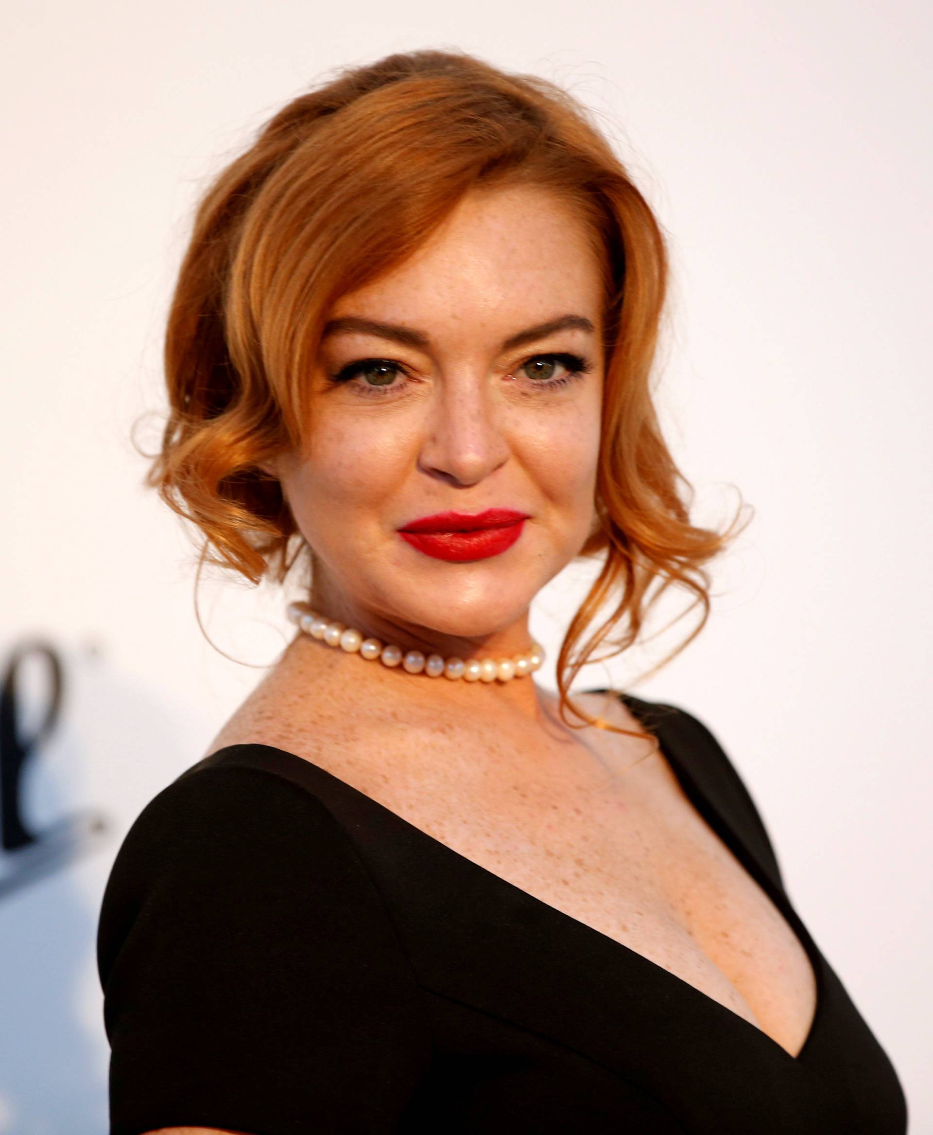 FILE PHOTO: Lindsay Lohan poses upon arrival at the 70th Cannes Film Festival The amfAR's Cinema Against AIDS 2017 event in Antibes