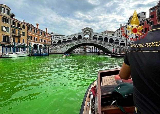 Venice's waters turn green due to an unknown substance near the Rialto Bridge