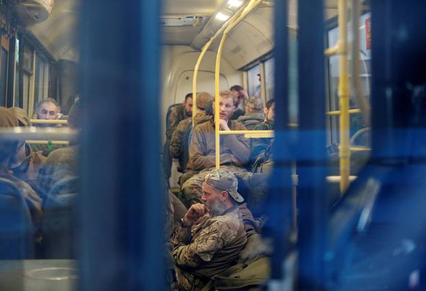 Buses carrying service members of Ukrainian forces who have surrendered after weeks holed up at Azovstal steel works arrive in Olenivka