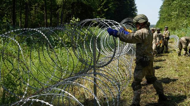 Lithuania toughens Belarus border with razor wire to bar migrants