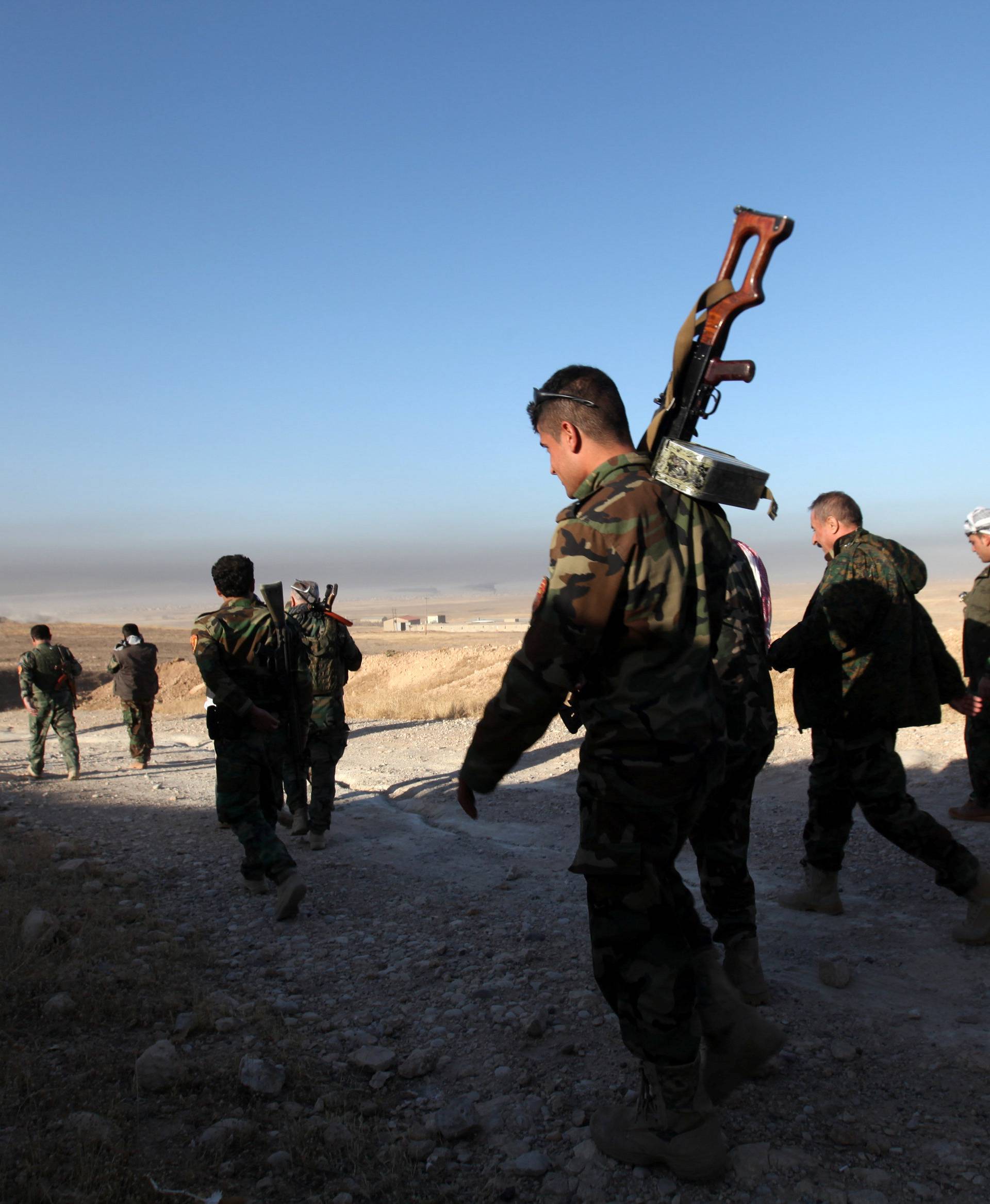 Peshmerga forces walk in the east of Mosul during operation to attack Islamic State militants in Mosul