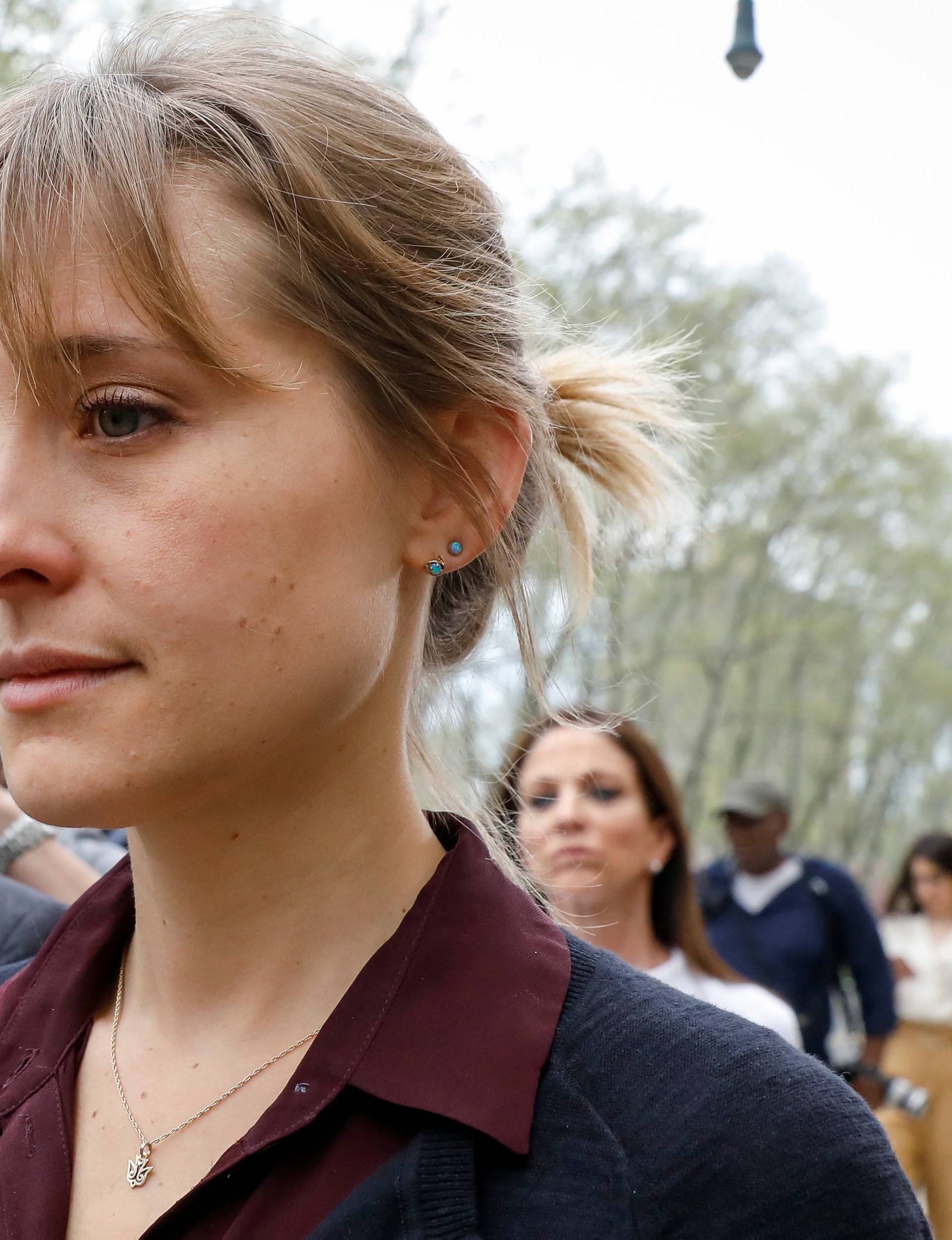 Actor Allison Mack, known for her role in the TV series 'Smallville', exits with her lawyer following a hearing on charges of sex trafficking in relation to the Albany-based organization Nxivm at United States Federal Courthouse in Brooklyn, New York