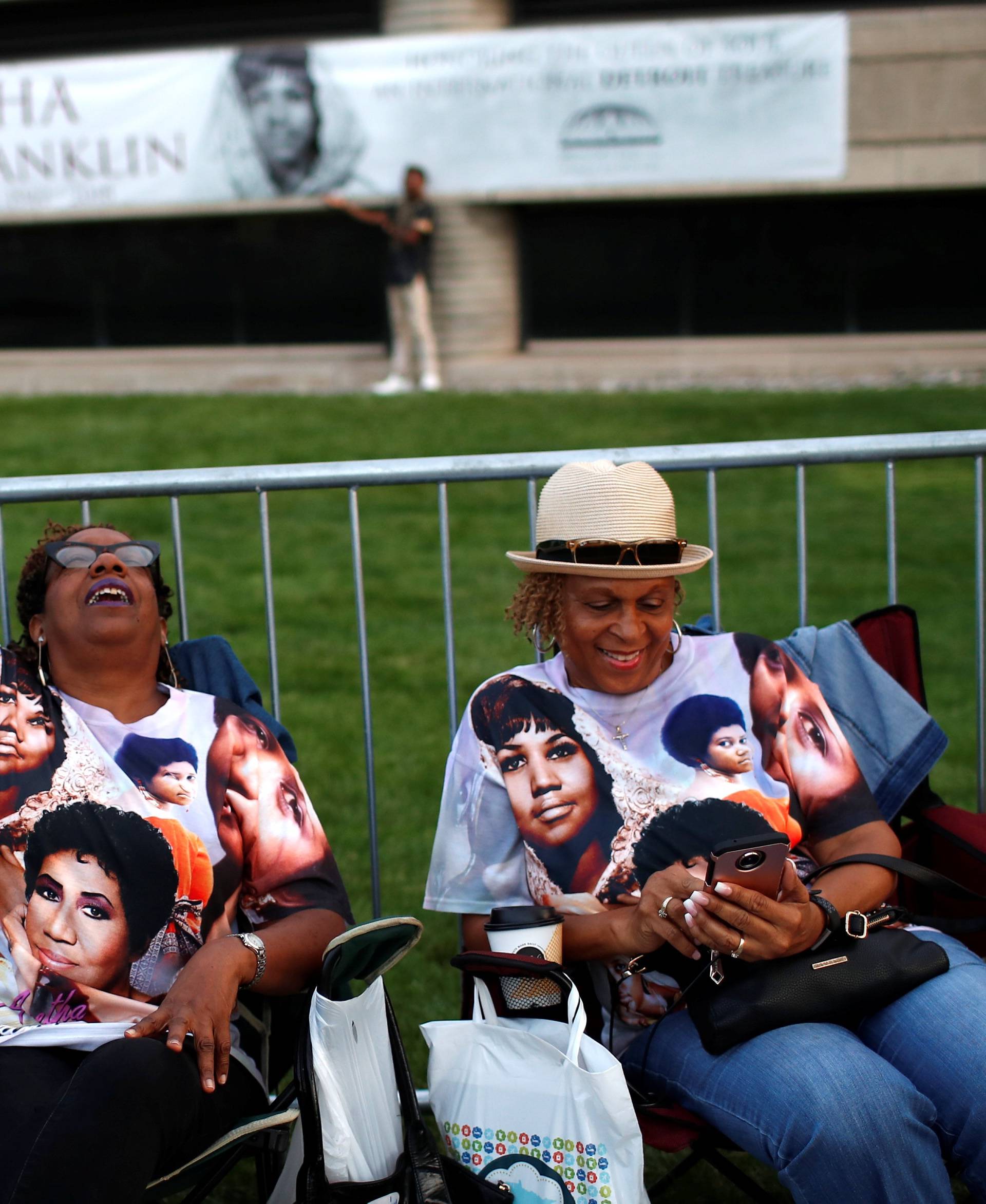 People wait in line outside the Charles H. Wright Museum of African American History where the late singer Aretha Franklin will lie in state in Detroit