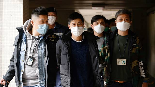 Pro-democracy activist Lester Shum is taken away by police officers in Hong Kong
