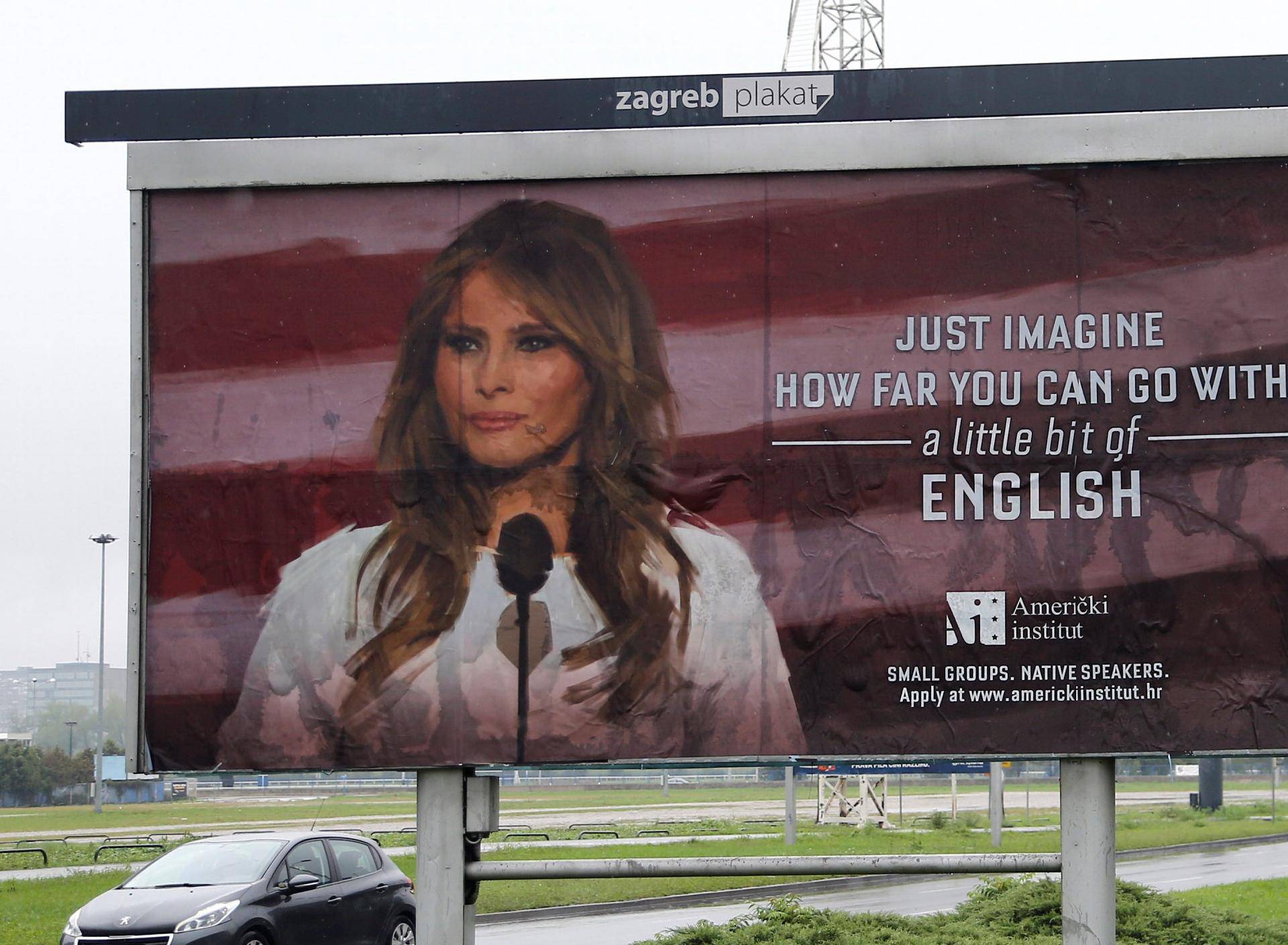 Cars drive near a billboard advertising a language school with the image of U.S. first lady Melania Trump in Zagreb, Croatia