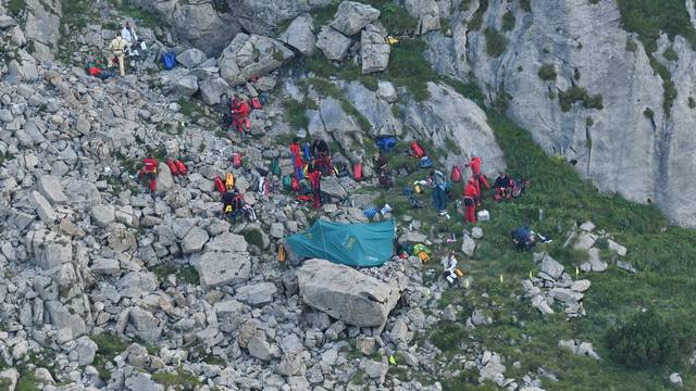 Mountain rescue team (TOPR) members are seen near cave entry during a search mission to save two cavers trapped in a cavern in Poland's Tatra mountains, near Zakopane