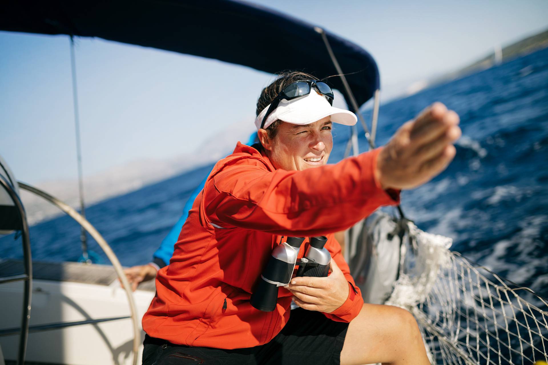 Attractive strong woman sailing with her boat